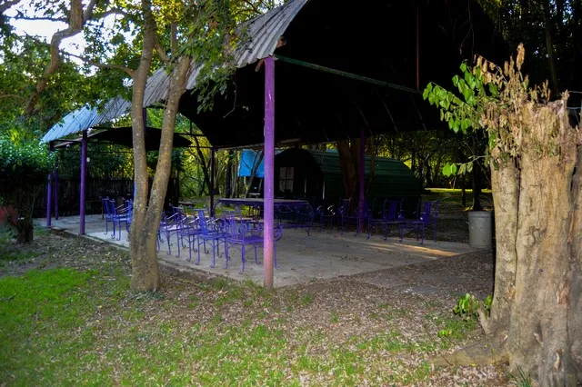 Shaded shelter with purple chairs