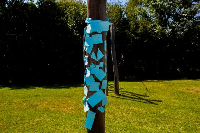 Pole covered in hand-written notes