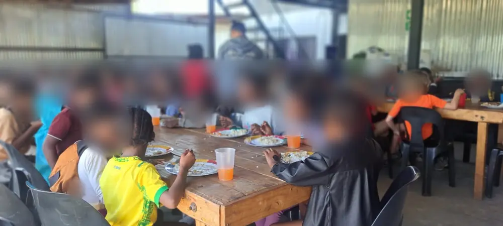 Kids eating together at long tables