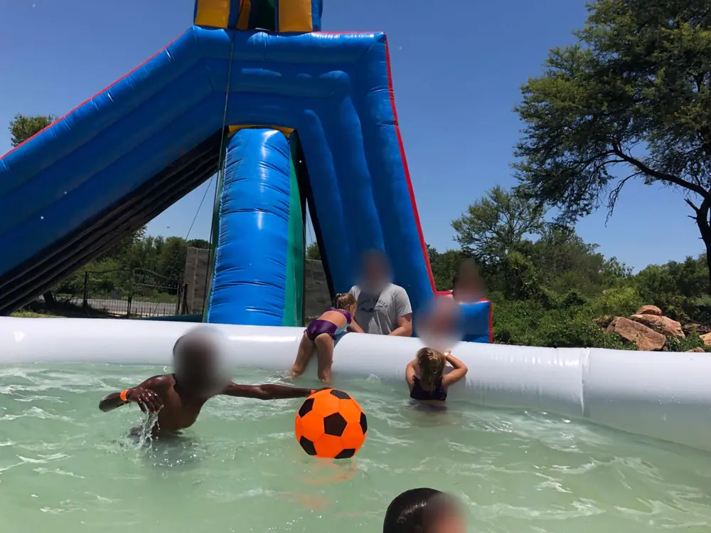 Kids playing ball in a splash pool