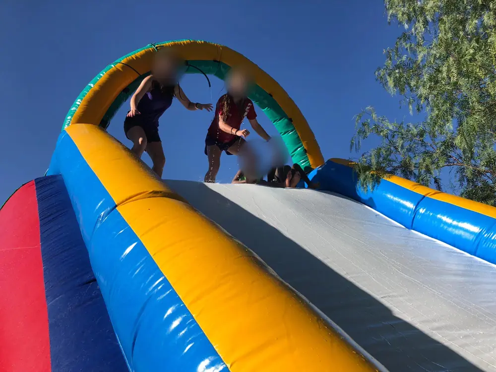Kids at the top of a water slide